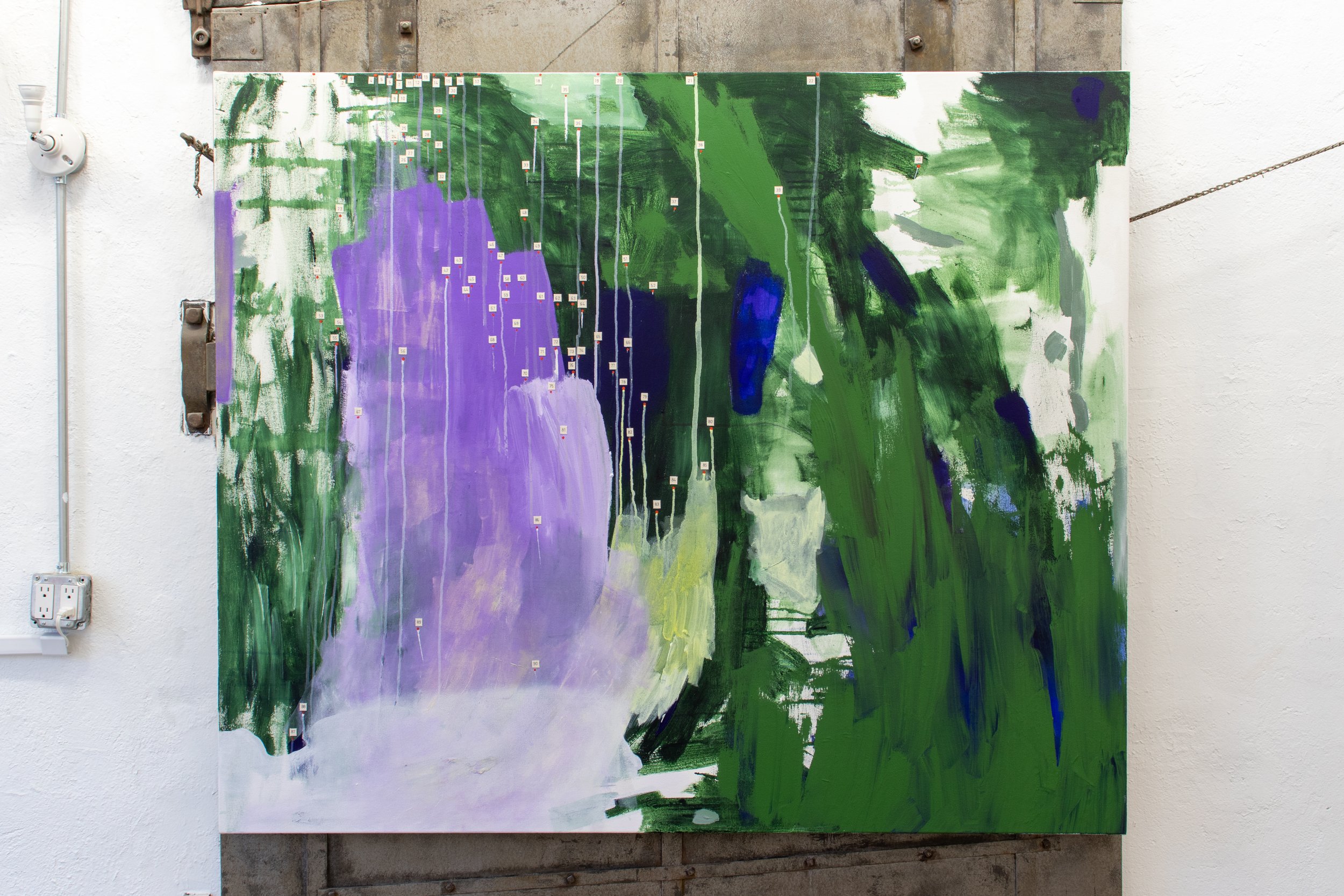 Large abstract painting with broad green, violet, white, and blue brushstrokes and numerous small numbered labels attached across the surface.